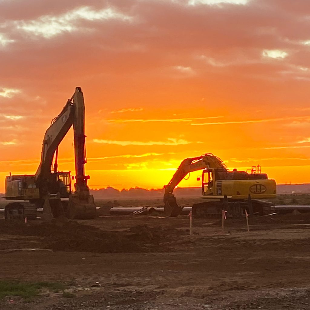 Two JJ Sprague Excavators at sunset in Phoenix, AZ