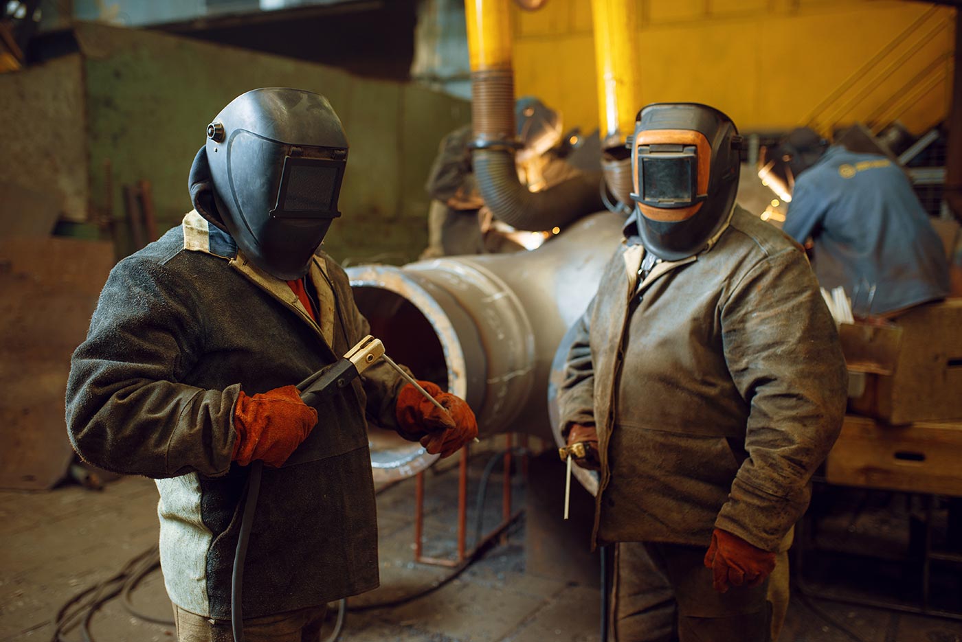 two-welder-in-masks-prepares-to-work-with-metal-KTPAD5L